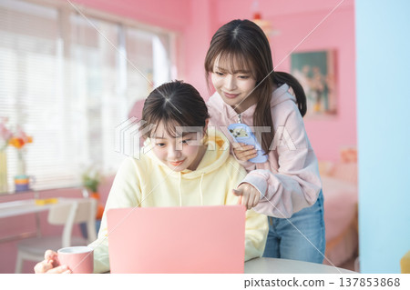 A woman using a computer in the living room A woman using a computer in the living room 137853868