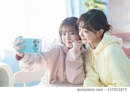 A woman taking a picture with a smartphone A woman taking a picture with a smartphone 137853875