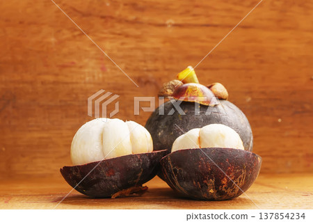 Peeled mangosteen fruit halves Peeled mangosteen fruit halves 137854234