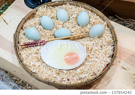 Duck eggs in basket 137854242