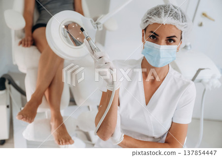 Podiatrist with client in clinic Podiatrist with client in clinic 137854447
