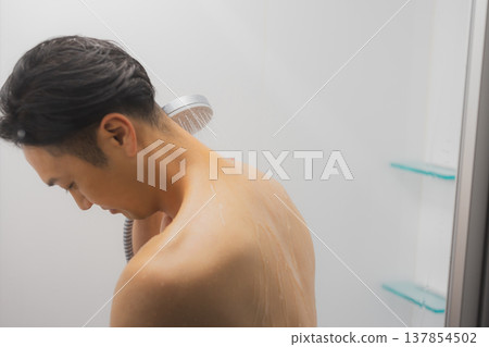 Men taking a shower Men taking a shower 137854502