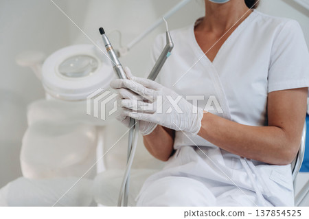 Close up view of podiatrist that is holding equipment in the clinic 137854525