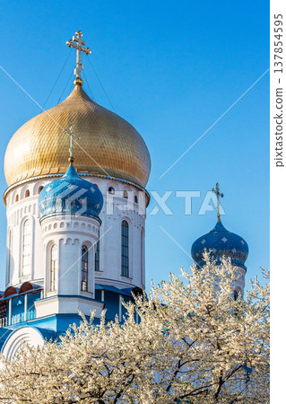 Uzhhorod, Ukraine - 22 March, 2014: Ukrainian Orthodox Church. Christ the Saviour Cathedral on Cyril and Methodius square in spring blossom. Christian architecture for Easter background Uzhhorod, Ukraine - 22 March, 2014: Ukrainian Orthodox Church. Christ the Saviour Cathedral on Cyril and Methodius square in spring blossom. Christian architecture for Easter background 137854595