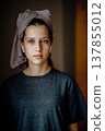 Natural portrait of a teen girl after a shower, with a towel on her head and earphones. Home lifestyle image for themes of morning routine, self care, natural skin and teenage everyday life. 137855012