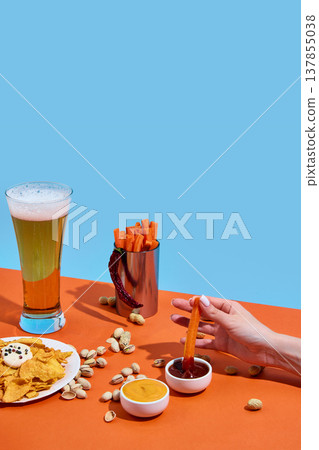 Beer with carrot sticks and dipping sauces on colorful background with copy space. Beer with carrot sticks and dipping sauces on colorful background with copy space. 137855038