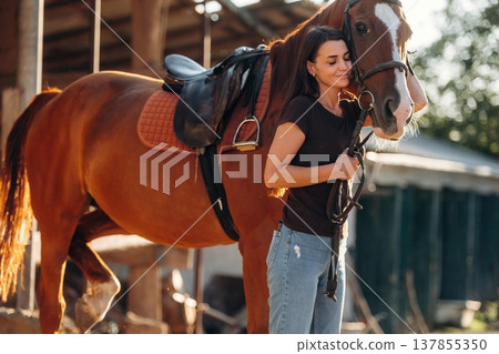 Non urban country scene. Woman is with horse on the farm Non urban country scene. Woman is with horse on the farm 137855350