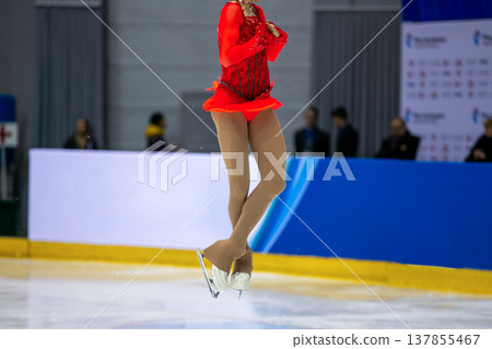 Female figure skater caught mid-air Female figure skater caught mid-air 137855467
