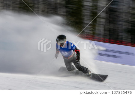 Snowboarder carving aggressive turn Snowboarder carving aggressive turn 137855476