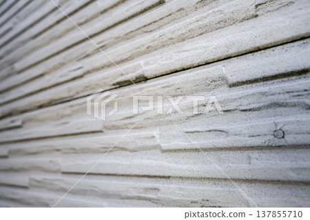 Exterior wall repair work on a detached house: deteriorated siding 137855710