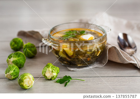 Hot green sorrel soup with Brussels sprouts in a bowl 137855787