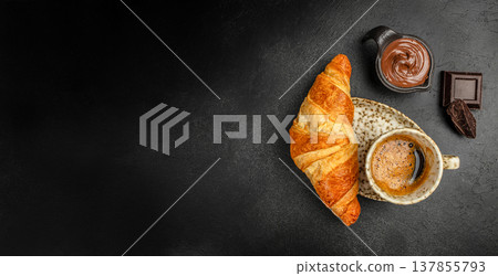 Croissant with Coffee and Chocolate Spread on Black Background 137855793