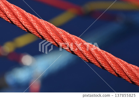 Red braided rope in close up with blurred background 137855825