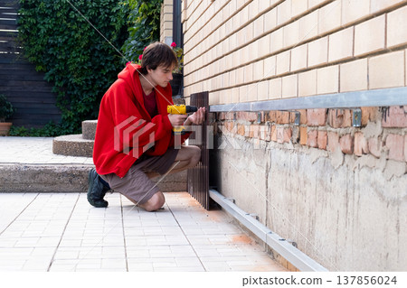 Worker installing house plinth with metal sheets during construction works 137856024