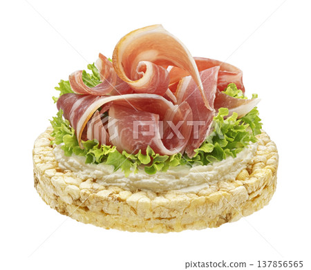 Bacon slices on rice cake with cream cheese and lettuce isolated on white background with clipping path, full depth of field Bacon slices on rice cake with cream cheese and lettuce isolated on white background with clipping path, full depth of field 137856565