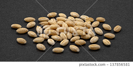 Barley grain pile on dark background, natural whole cereal ingredient, full depth of field, top view 137856581