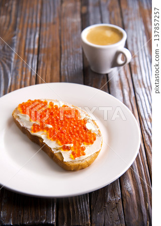 Sandwiches with red caviar, salmon on a slice of bread with cream cheese. Sandwiches with red caviar, salmon on a slice of bread with cream cheese. 137857257