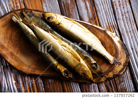 smoked fish on wooden board smoked fish on wooden board 137857262