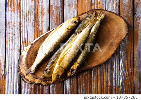 smoked fish on wooden board smoked fish on wooden board 137857263