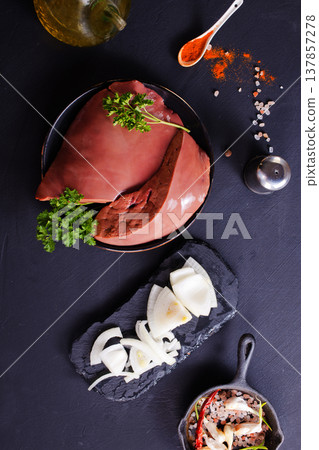 Image of raw liver with onion and greens during cooking Image of raw liver with onion and greens during cooking 137857278
