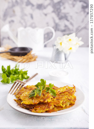 Close up view of potato pancakes. Potatoes pancakes on white plate Close up view of potato pancakes. Potatoes pancakes on white plate 137857290