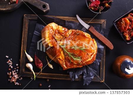 Raw meat. Raw pork ribs in marinade with spices, rosemary, tomato sauce and garlic Raw meat. Raw pork ribs in marinade with spices, rosemary, tomato sauce and garlic 137857303