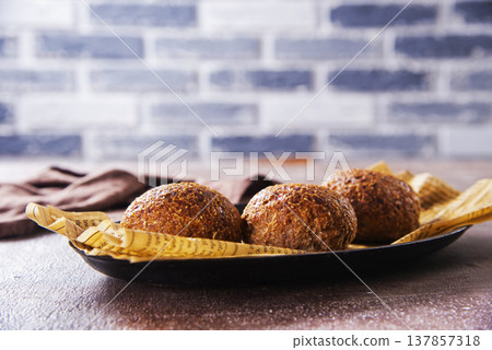 Homemade buns on a baking sheet. Delicious breakfast Homemade buns on a baking sheet. Delicious breakfast 137857318