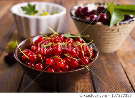 Red currant berries, fresh ripe and raw redcurrants in a claim bowl. Ready to eat spherical edible fruits 137857335