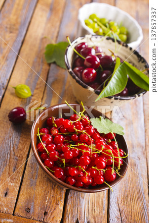 Red currant berries, fresh ripe and raw redcurrants in a claim bowl. Ready to eat spherical edible fruits 137857337