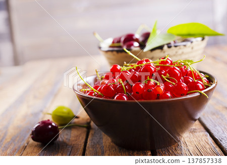Red currant berries, fresh ripe and raw redcurrants in a claim bowl. Ready to eat spherical edible fruits 137857338