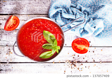Flat lay composition with delicious tomato cream soup in bowl on white wooden table. Flat lay composition with delicious tomato cream soup in bowl on white wooden table. 137857409
