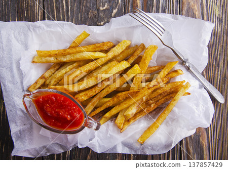 Homemade French fries with ketchup, homemade roasted in the air fryer. Homemade French fries with ketchup, homemade roasted in the air fryer. 137857429