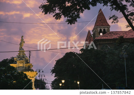 Streets of Colaba in Mumbai, India at evening time. Beautiful buildings in British style Streets of Colaba in Mumbai, India at evening time. Beautiful buildings in British style 137857842