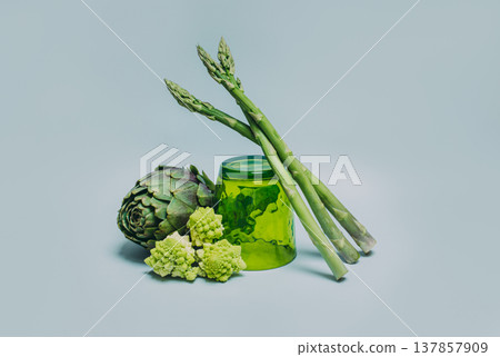 Fresh Artichoke, Asparagus and Romanesque cabbage on a grey background. 137857909