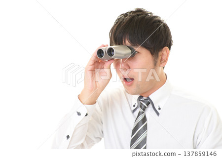A surprised man holding binoculars A surprised man holding binoculars 137859146