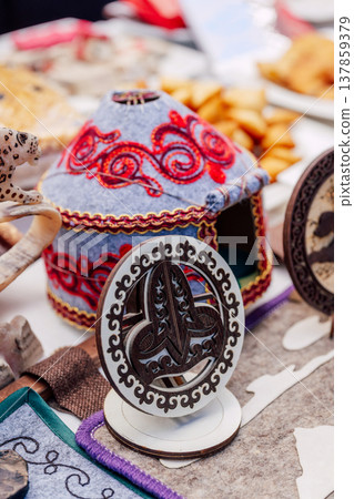 national kazakh souvenirs on the table. kazakh toy yurt and wooden figurine national kazakh souvenirs on the table. kazakh toy yurt and wooden figurine 137859379