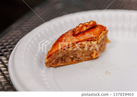Vibrant Scene Of Honeyglazed Phyllo Pastry With Walnuts Displayed On Street Food Ceramic Dish Vibrant Scene Of Honeyglazed Phyllo Pastry With Walnuts Displayed On Street Food Ceramic Dish 137859403