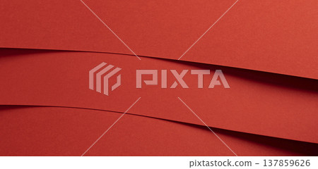 Horizontal red paper bands create a bold layered background with graphic rhythm. Smooth matte strips 137859626