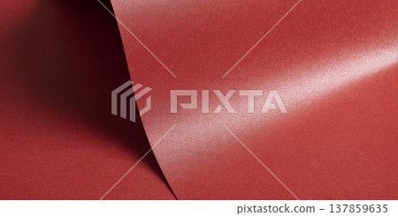 Metallic red paper catches light along a diagonal fold creating a luminous backdrop. Glossy satin Metallic red paper catches light along a diagonal fold creating a luminous backdrop. Glossy satin 137859635