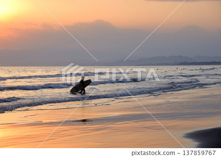 Sunset view of Kugenuma Beach and the silhouettes of surfers Sunset view of Kugenuma Beach and the silhouettes of surfers 137859767