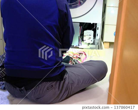 Man repairing the washing machine 137860417