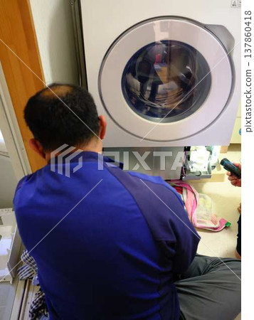 Man repairing the washing machine 137860418