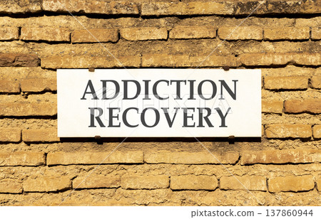 Addiction recovery symbol. Concept words Addiction recovery on beautiful big white sign plate. Beautiful old brown brick wall background. Psychology addiction recovery concept. Copy space. Addiction recovery symbol. Concept words Addiction recovery on beautiful big white sign plate. Beautiful old brown brick wall background. Psychology addiction recovery concept. Copy space. 137860944