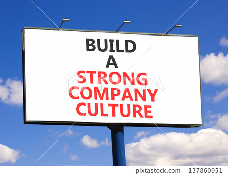 Strong company culture symbol. Concept words Build a strong company culture on beautiful white billboard. Beautiful blue sky background. Business strong company culture concept. Copy space. 137860951
