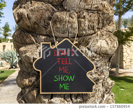 Tell or show symbol. Concept words Do not tell me, show me on beautiful black blackboard. Beautiful old palm tree background. Business tell or show concept. Copy space. Tell or show symbol. Concept words Do not tell me, show me on beautiful black blackboard. Beautiful old palm tree background. Business tell or show concept. Copy space. 137860954