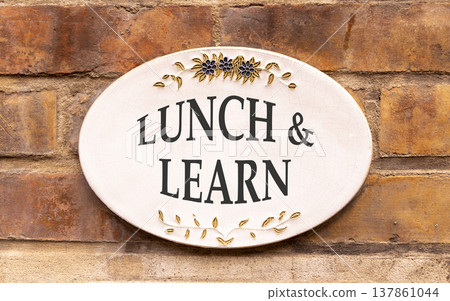 Lunch and learn symbol. Concept words Lunch and learn on beautiful big white sign plate. Beautiful old brown brick wall background. Business, educational and lunch and learn concept. Copy space. Lunch and learn symbol. Concept words Lunch and learn on beautiful big white sign plate. Beautiful old brown brick wall background. Business, educational and lunch and learn concept. Copy space. 137861044