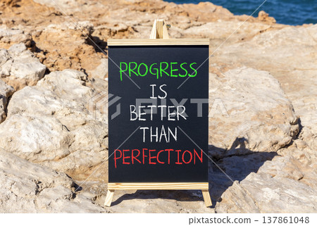 Progress or perfection words symbol. Concept words Progress is better than perfection on beautiful black blackboard. Beautiful stone background. Business progress or perfection concept. Copy space. 137861048