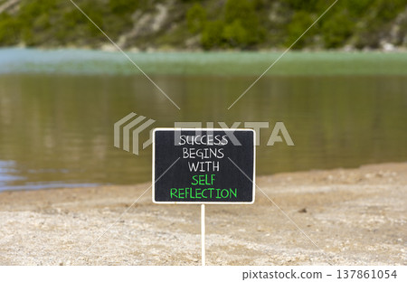 Self reflection symbol. Concept words Success begins with self reflection on beautiful blackboard. Beautiful mountain lake background. Business success begins with self reflection concept. Copy space. Self reflection symbol. Concept words Success begins with self reflection on beautiful blackboard. Beautiful mountain lake background. Business success begins with self reflection concept. Copy space. 137861054