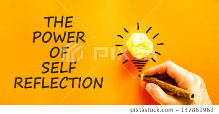Self reflection symbol. Concept words The power of self reflection on beautiful orange paper. Beautiful orange background. Businessman's hand. Business the power of self reflection concept. Copy space 137861961