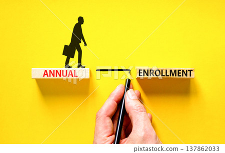 Annual enrollment words symbol. Concept words Annual enrollment on beautiful wooden blocks. Beautiful yellow background. Doctor hand. Medical and Annual enrollment words concept. Copy space. 137862033